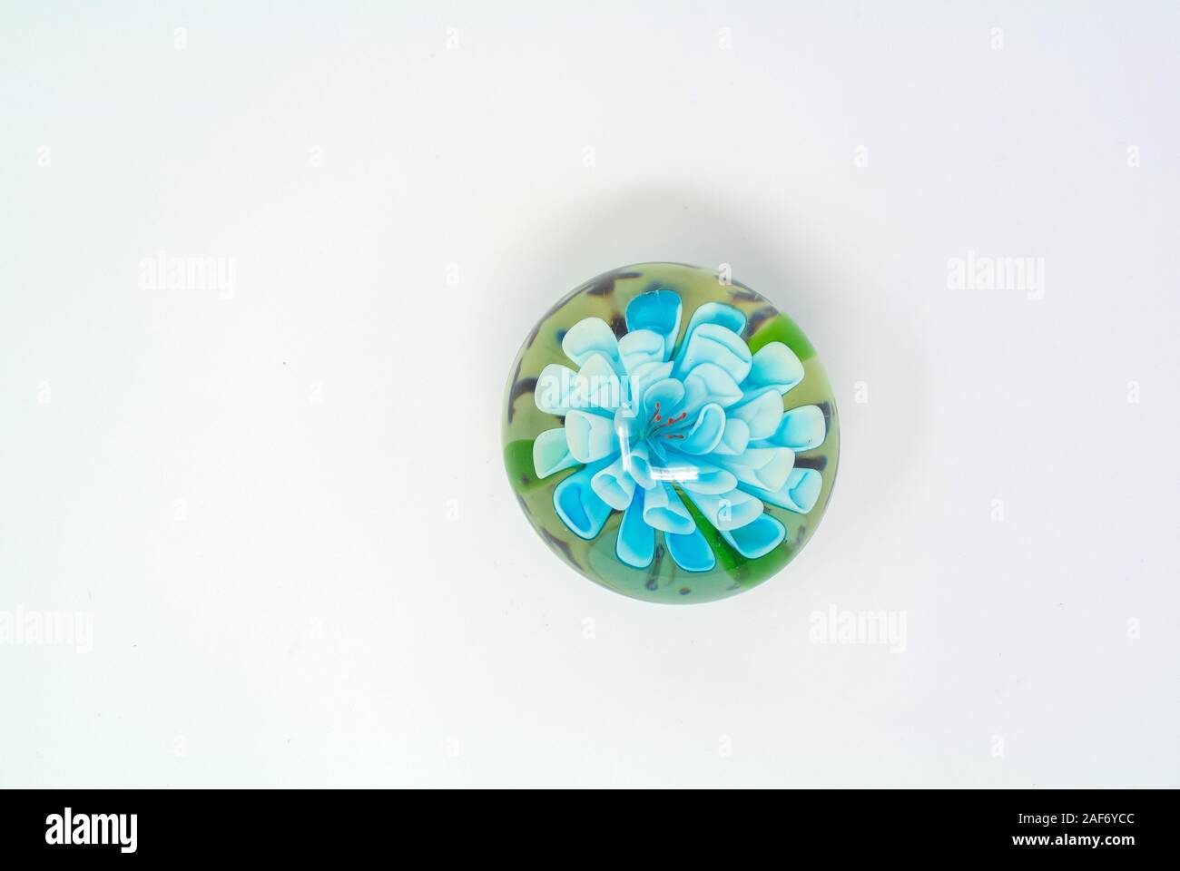 paperweight with blue flower with white background Stock Photo
