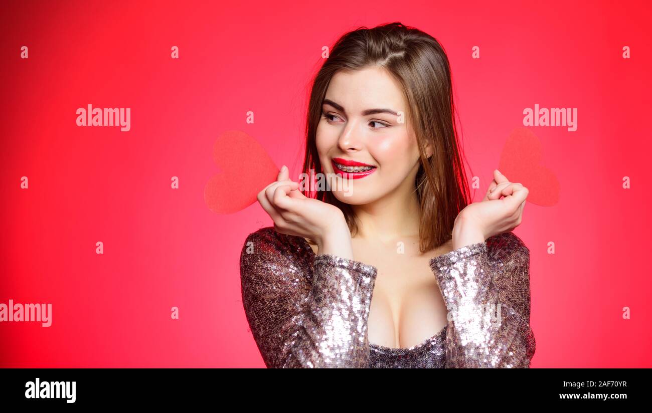 How to kiss with braces. Woman makeup red lips hold heart symbol love