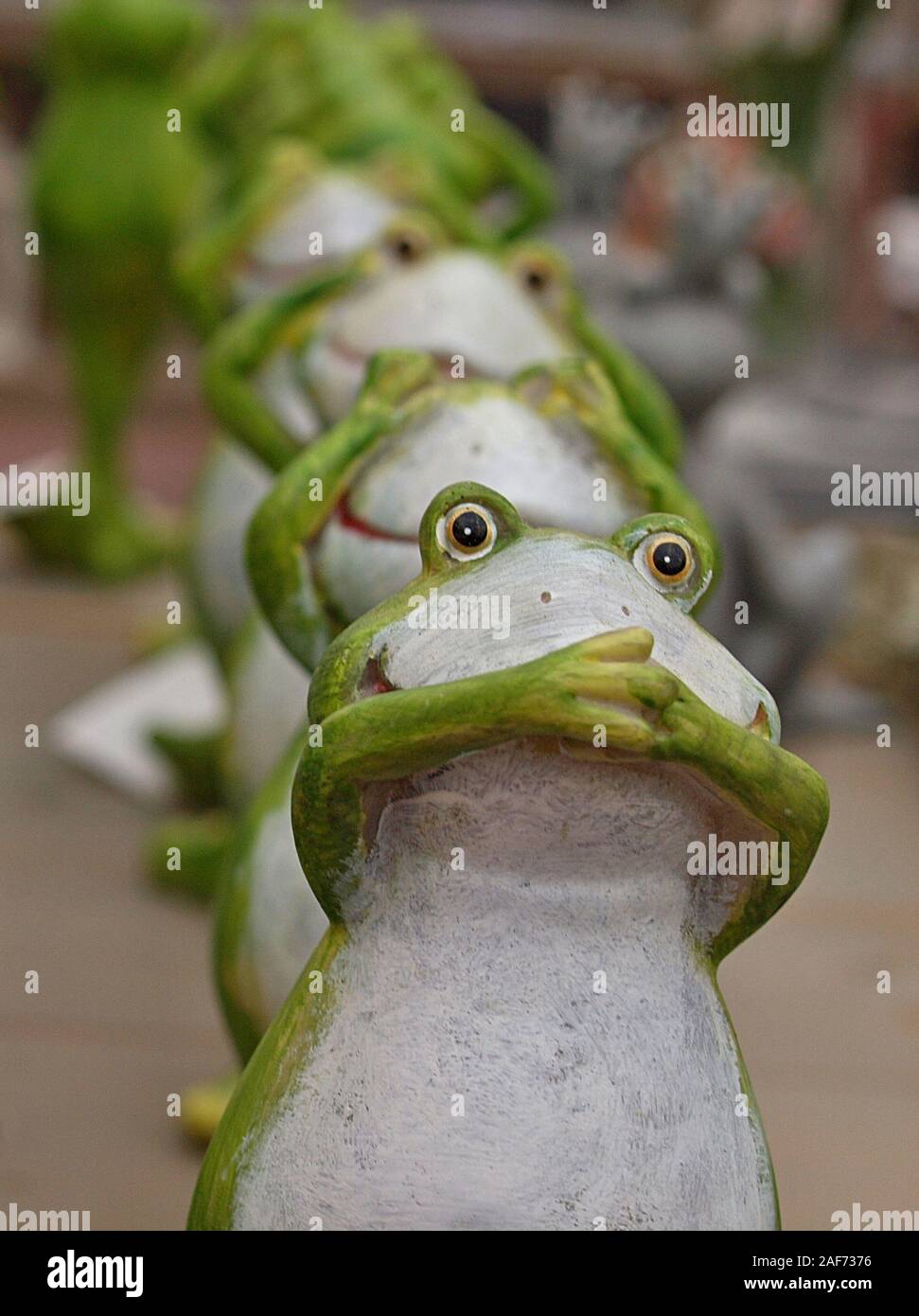 Cute ceramic frogs in a row Stock Photo Alamy