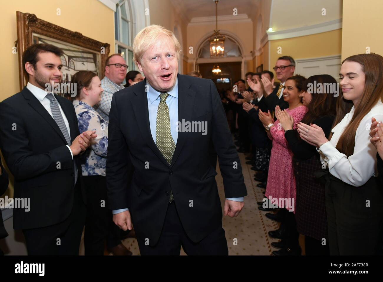 Prime Minister Boris Johnson is greeted by staff as he arrives back at 10 Downing Street, London, after meeting Queen Elizabeth II and accepting her invitation to form a new government after the Conservative Party was returned to power in the General Election with an increased majority. Stock Photo