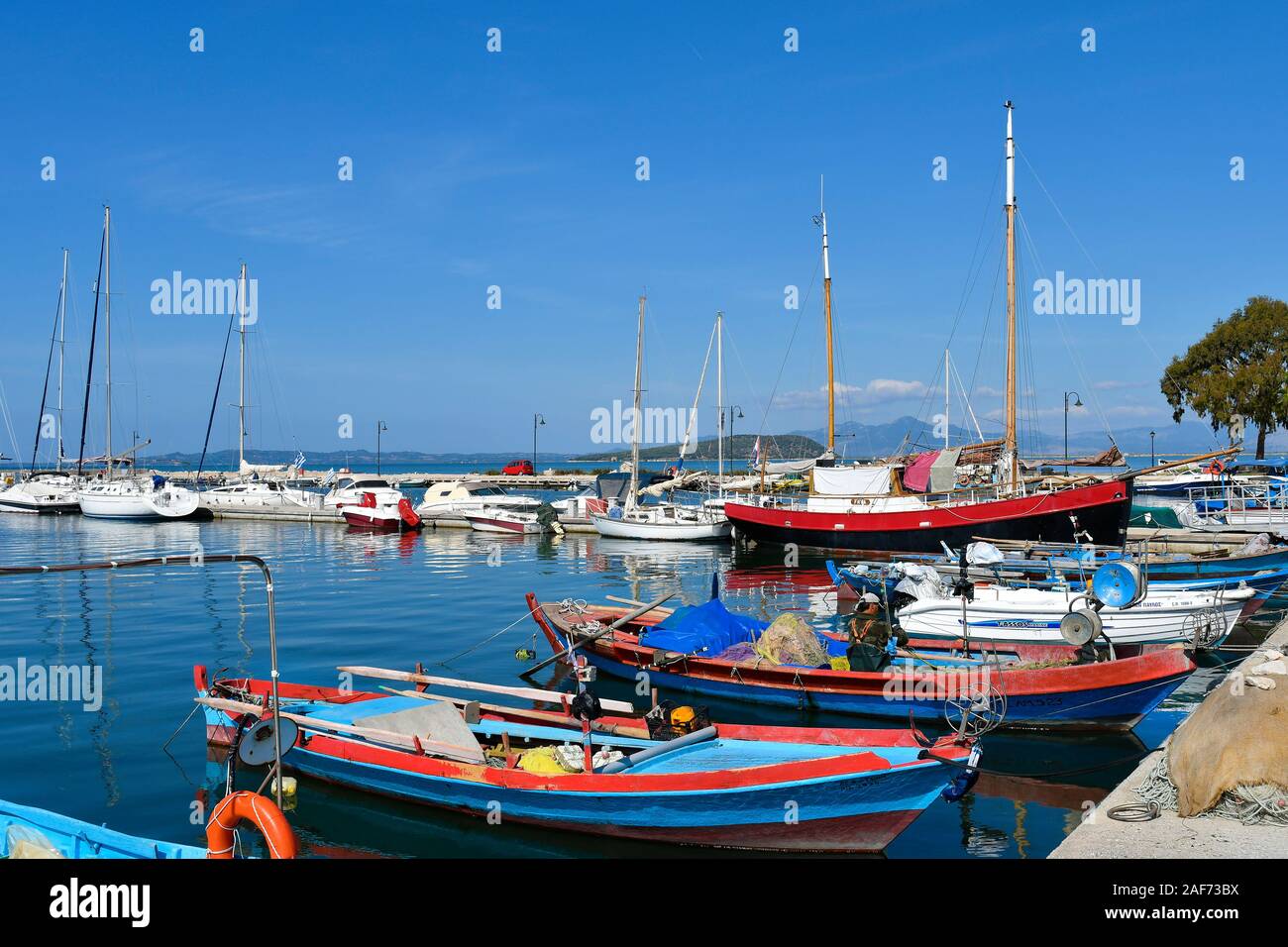 Greece, Epirus, ships and yachts in the harbor of Koronissia village situated in Ambracian Gulf Stock Photo