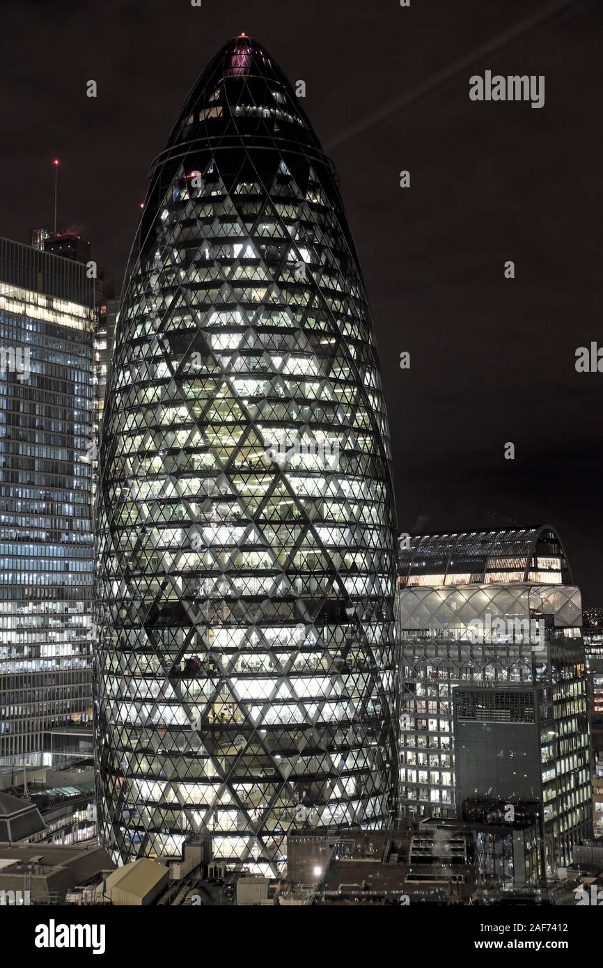 Vertical view of the gherkin skyscraper at night in winter December in the City of London cityscape London England UK   KATHY DEWITT Stock Photo
