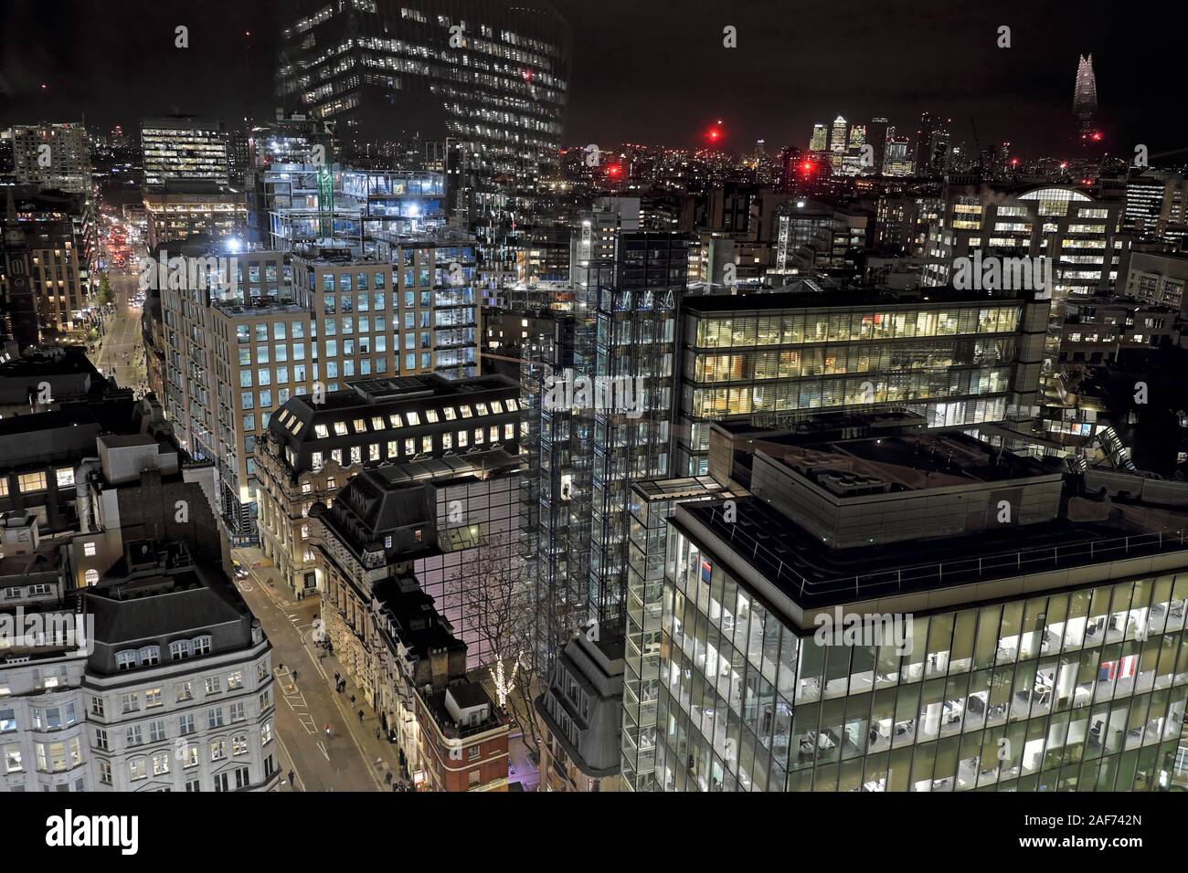 Cityscape view at night looking east of buildings on Fenchurch Street and Whitechapel High Street and the White Chapel building London E1 KATHY DEWITT Stock Photo
