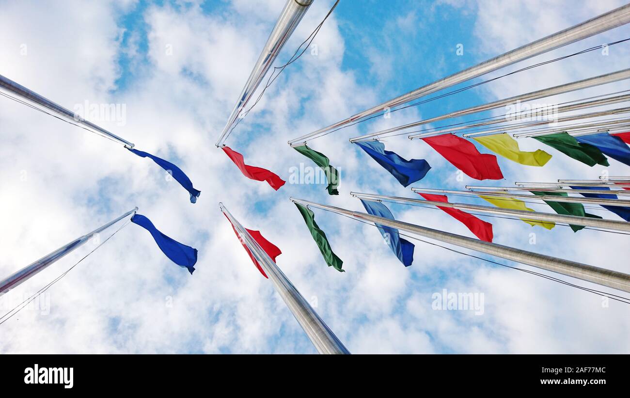 Colorful flags under the blue sky and white clouds Stock Photo - Alamy