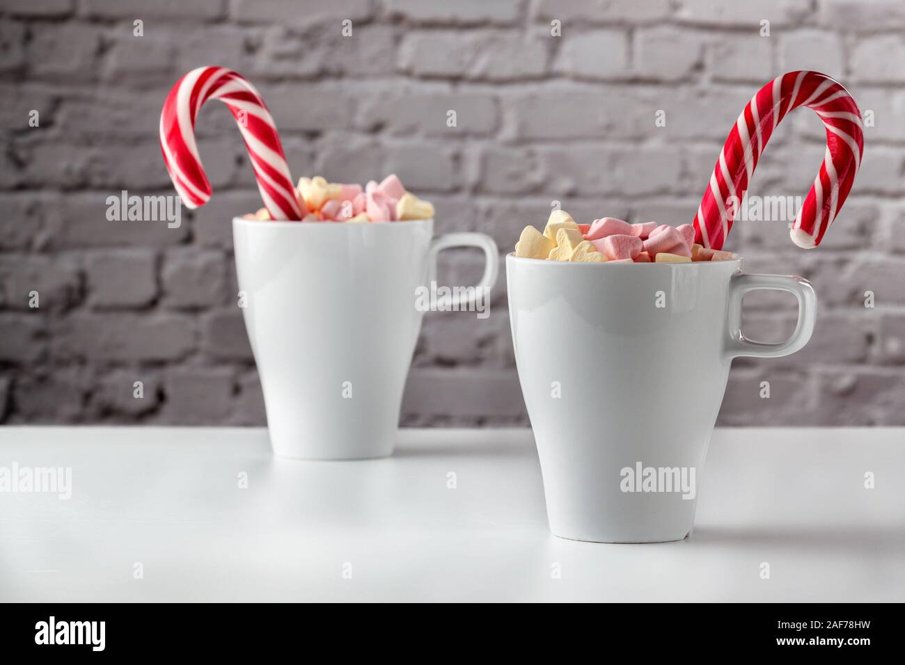 marshmallows and a cup of latte on a white table Stock Photo