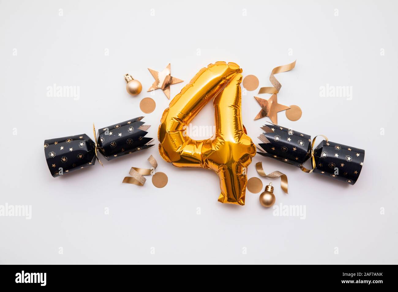 Christmas countdown. Gold number 4 with festive cristmas cracker decorations Stock Photo
