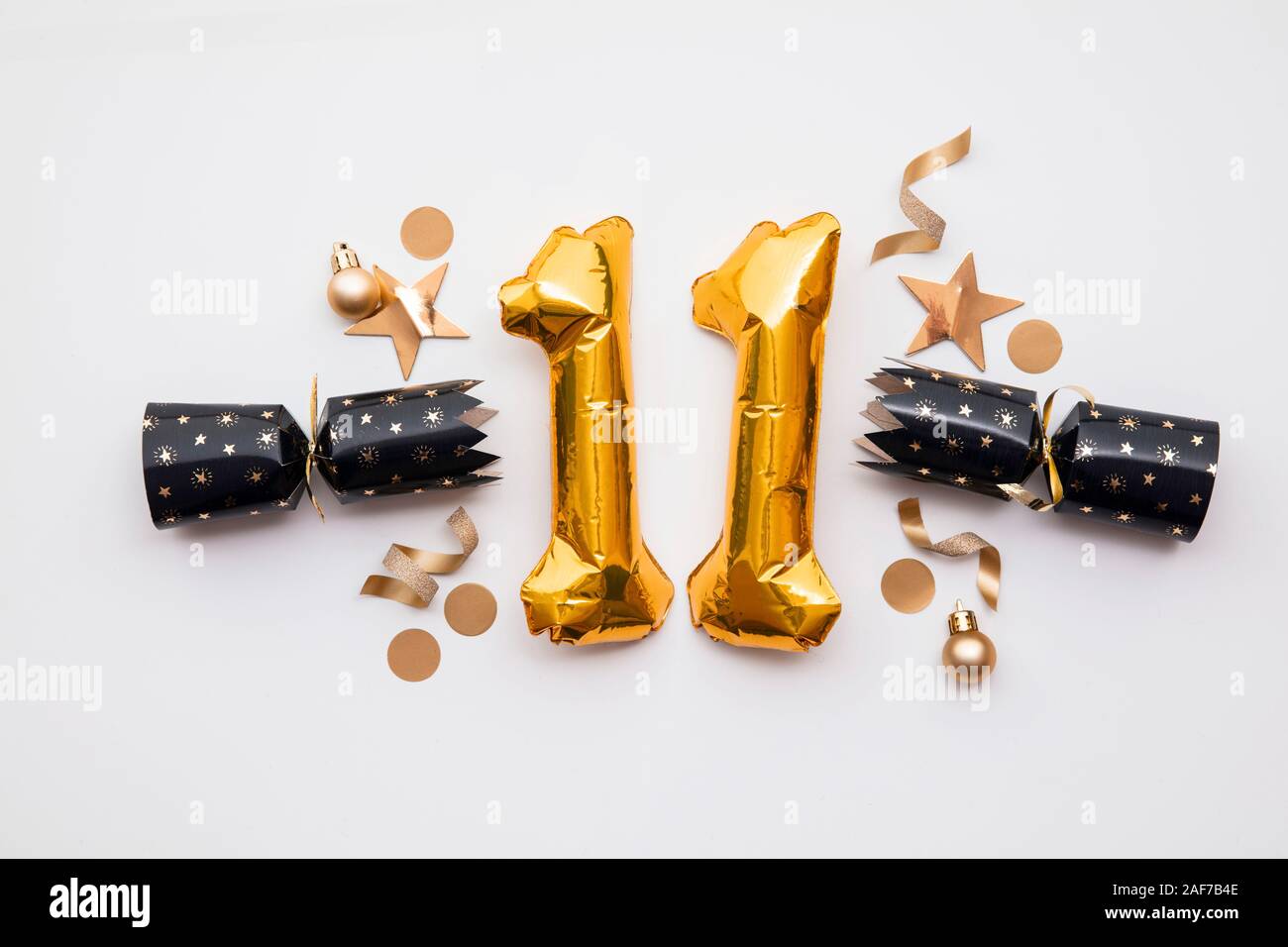 Christmas countdown. Gold number 11 with festive cristmas cracker decorations Stock Photo