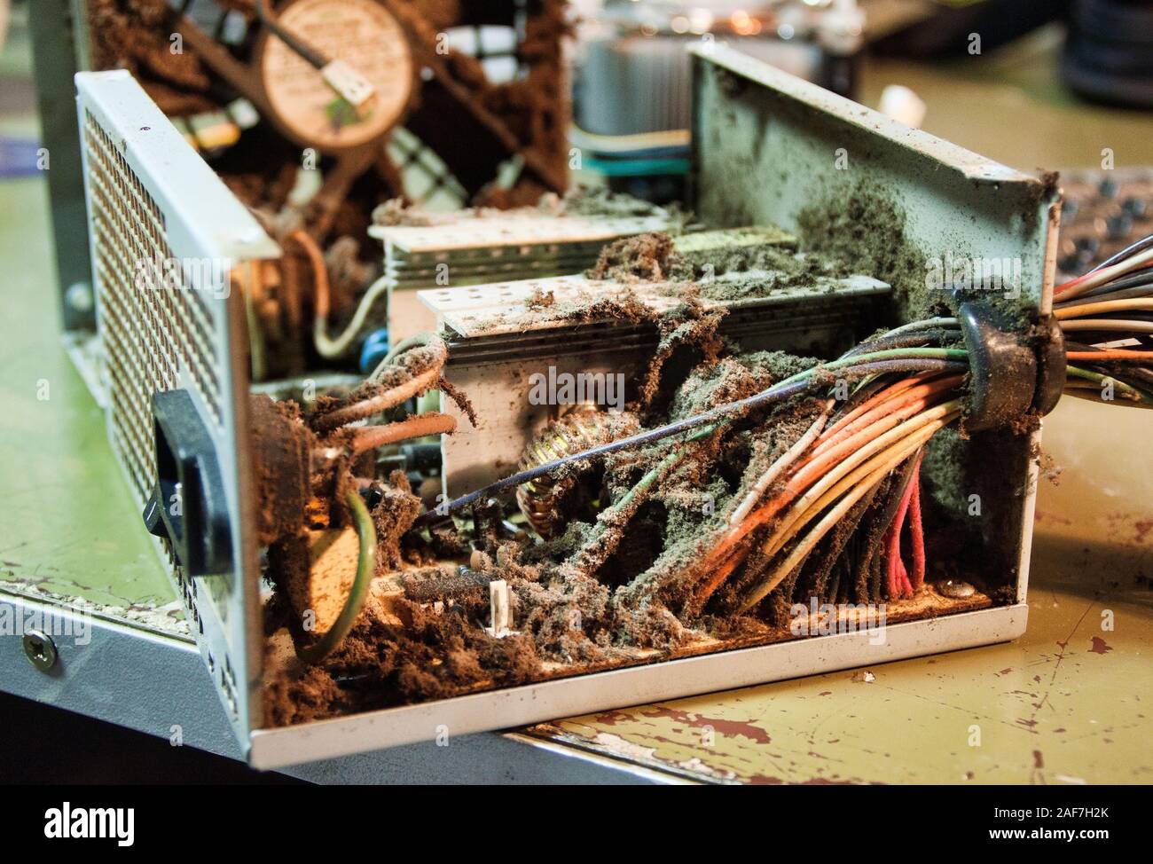 Broken computer power supply with a lot of dirt and dust. Stock Photo