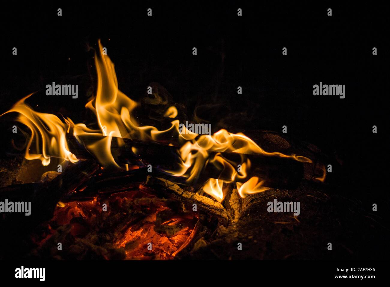 Isolated shot of small camp fire in the night. Stock Photo