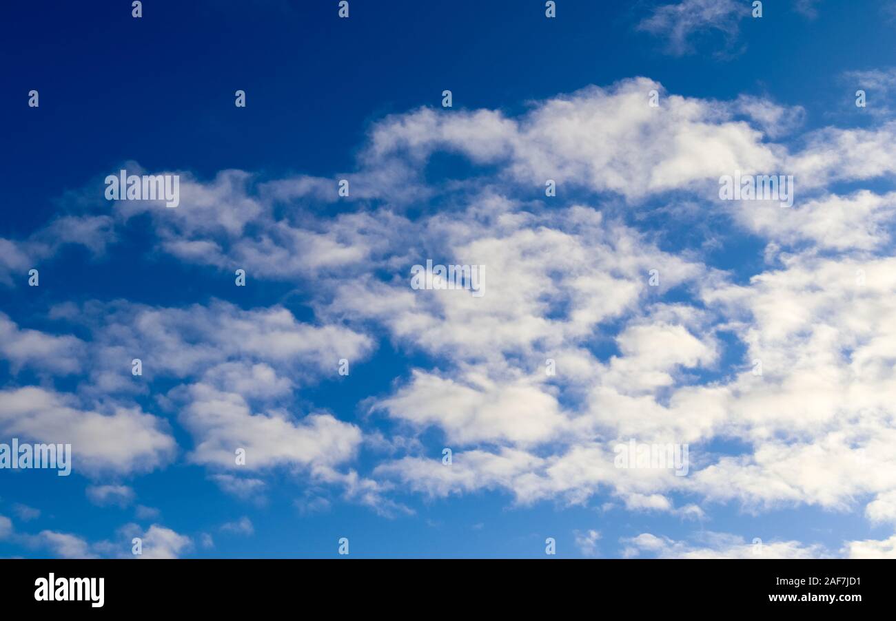 Beautiful fluffy clouds on a deep blue sky Stock Photo - Alamy