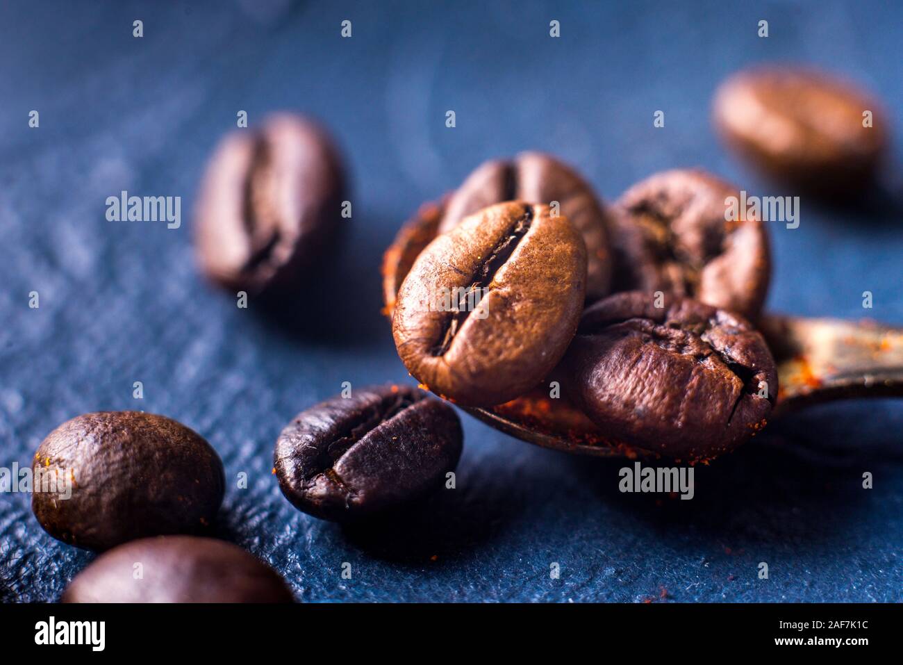 Close-up of coffee beans on a roasted heap on a blue background Stock Photo