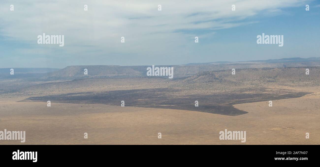 Tanzania.  Aerial View, Controlled Burning Bounded by Roadways, Serengeti National Park. Stock Photo
