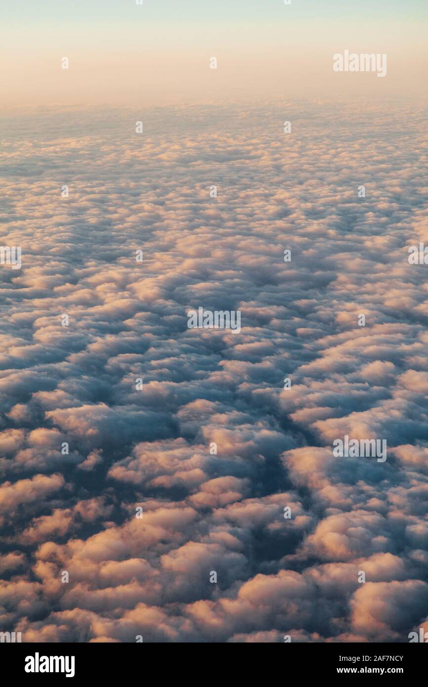 flying above the clouds at sunset landscape from an airplane Stock ...