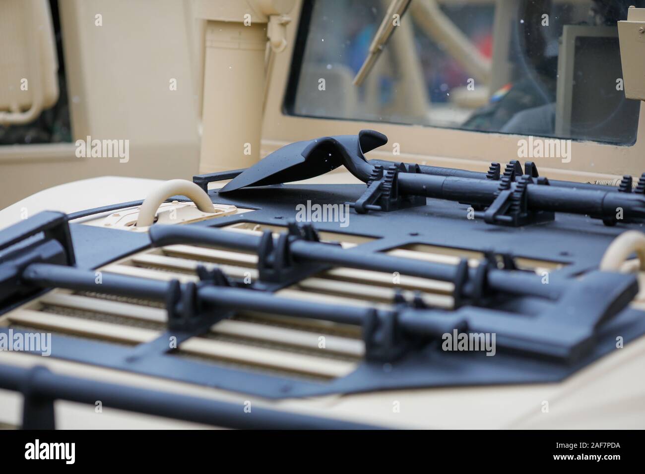 Tools mounted on the hood of a Humvee military vehicle - hammer, axe, shovel and pickaxe Stock Photo