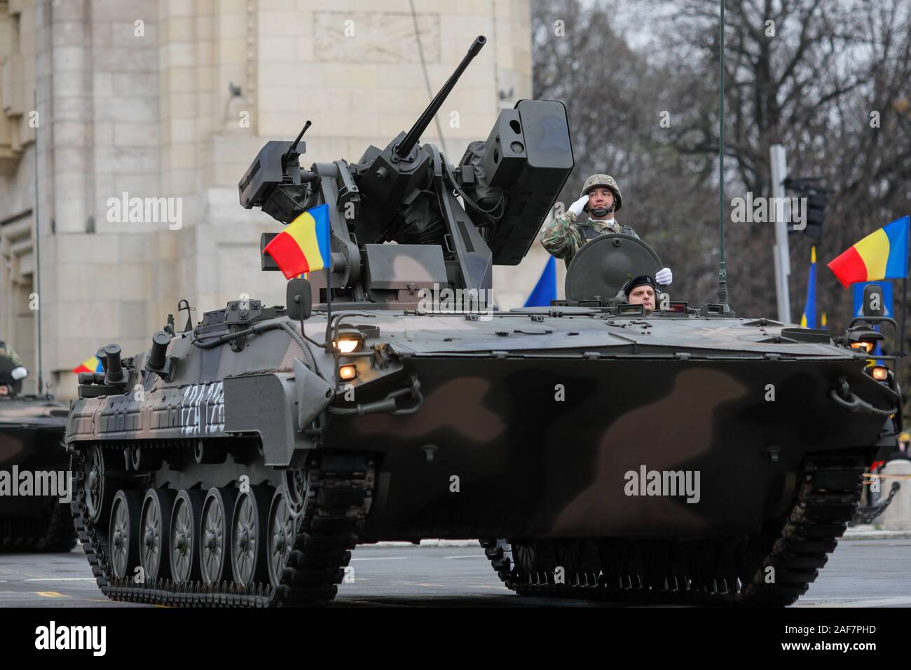 BUCHAREST, ROMANIA - December 1, 2019: MLI 84 M combat armored vehicle, at Romanian National Day military parade passes under the Arch of Triumph Stock Photo