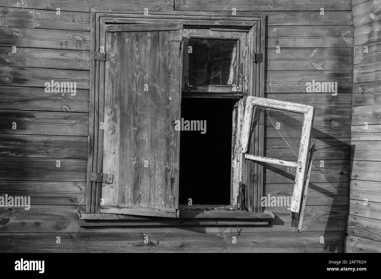 Broken window frame of old wooden house. Stock Photo