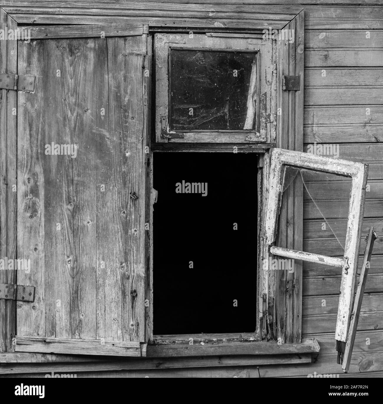 Broken window frame of old wooden house. Stock Photo