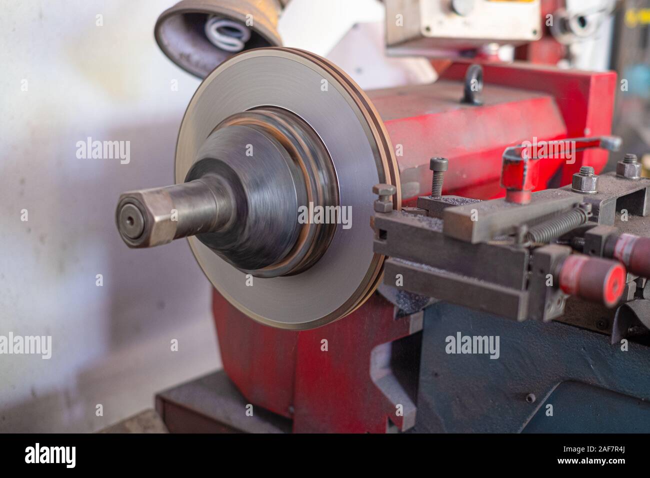 Mechanic man repairing brake use lathe tool polishing disc brakes of cars working automatic