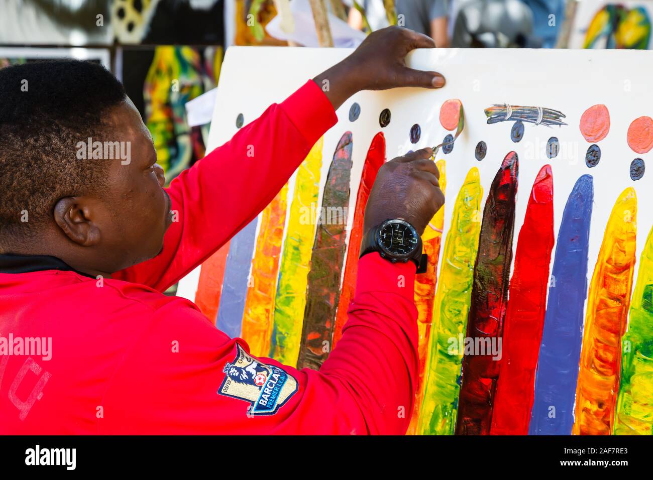 Tanzania.  Mto wa Mbu. Artist Painting in 'Kisu' (Knife) Style. Stock Photo