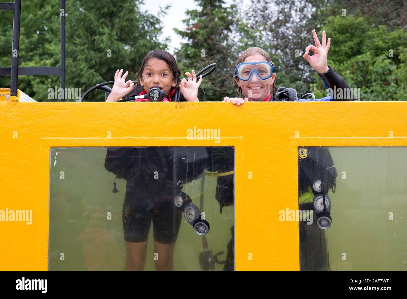 training for scuba diving, woman and girl making the safe sign Stock