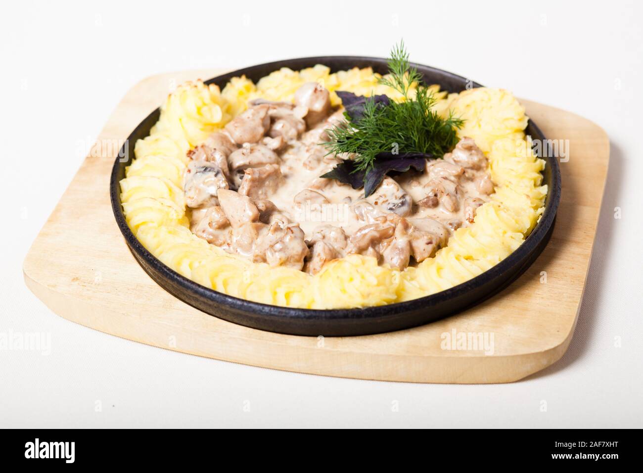 Rabbit stew in cream sauce with mushrooms and mashed potato Stock Photo