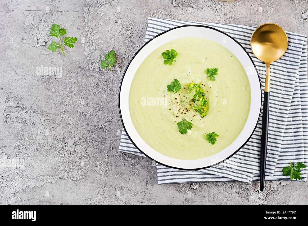 Homemade broccoli cream soup with croutons in white bowl on grey ...