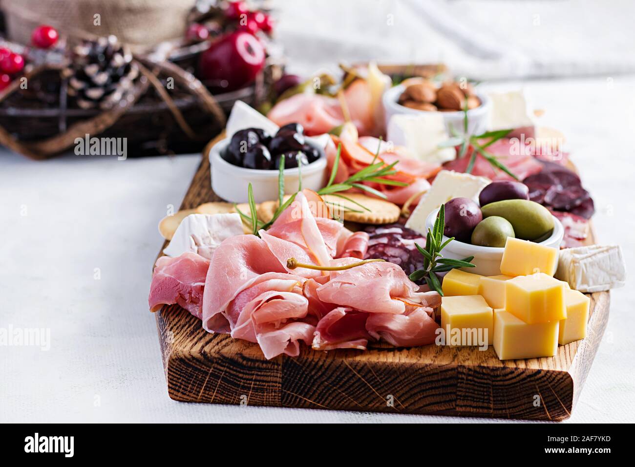 Antipasto platter with ham, prosciutto, salami, cheese, crackers and