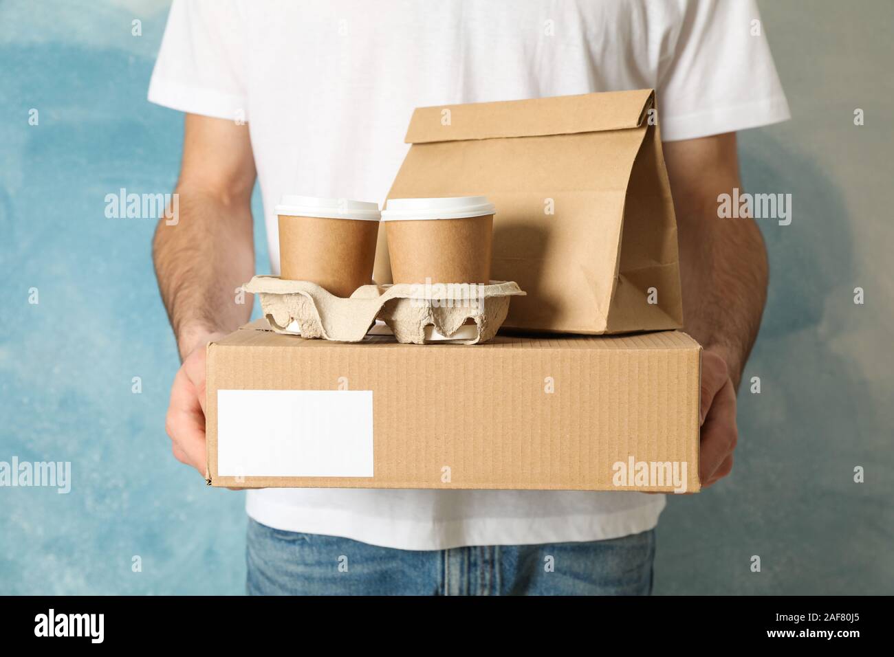 Man Holds Blank Box Coffee Cups And Paper Package Indoor Space For Text Stock Photo Alamy