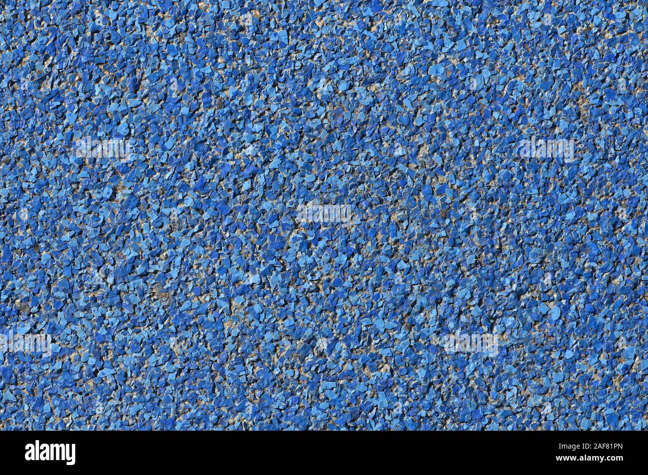 abstract blue background paving consisting of small pebbles embedded in cement exterior floor or road design Stock Photo