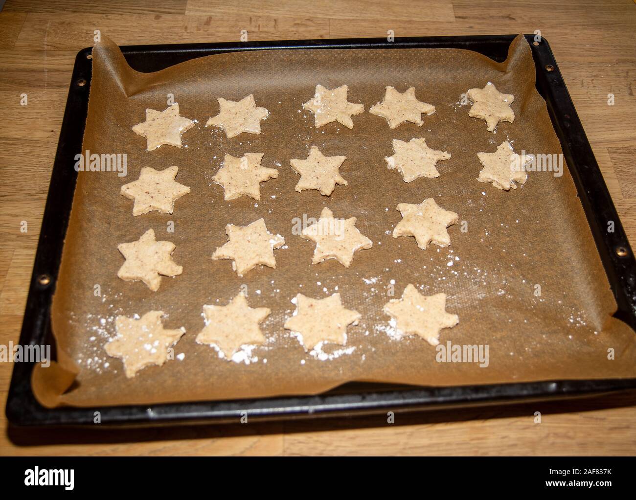 Star shaped Christmas cookies in an oven tray before baking Stock