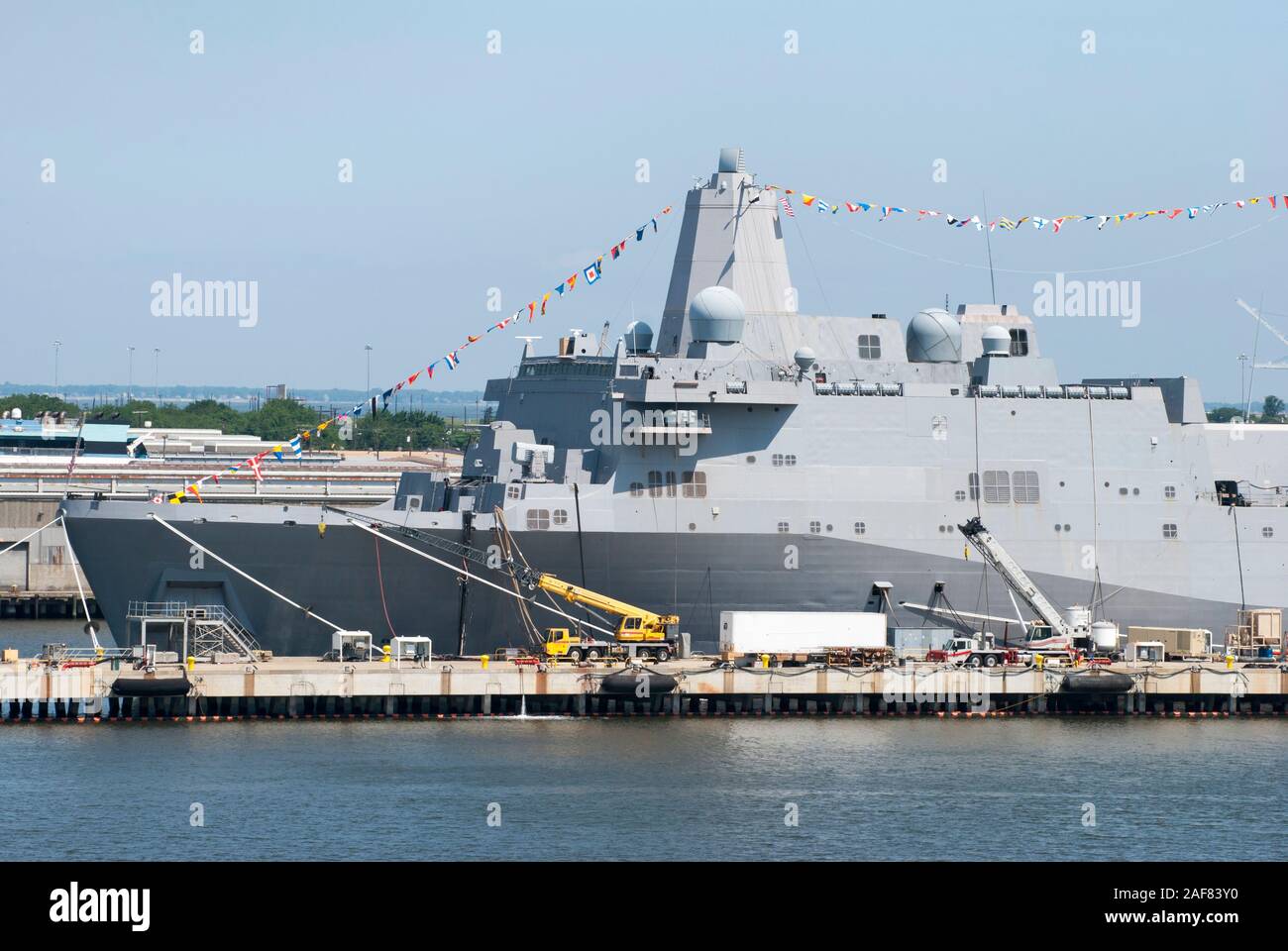 Two cranes serving the navy ship moored in a military base outside Norfolk city (West Virginia). Stock Photo