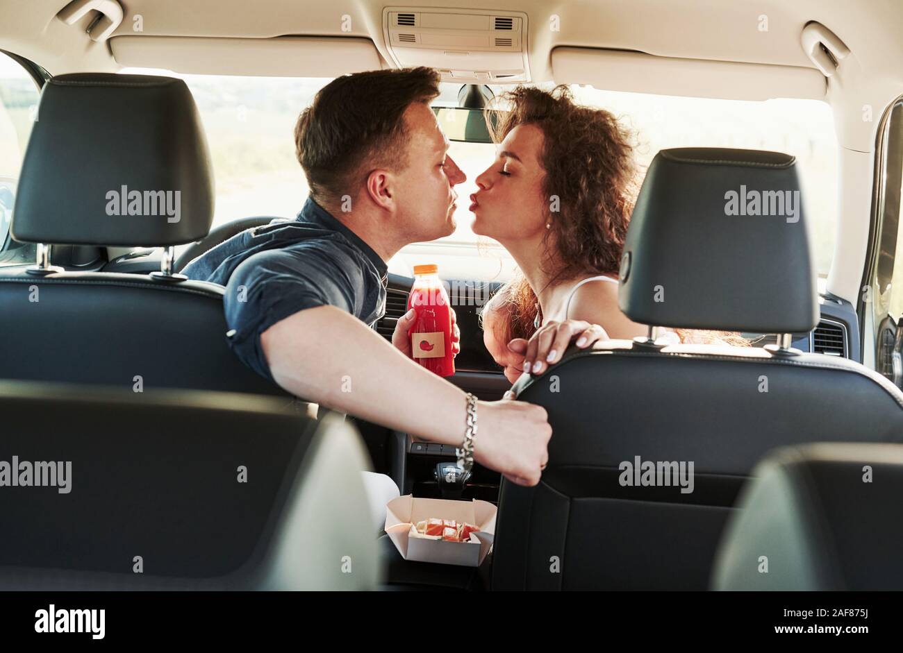 Love and food. Beautiful people is in the modern car at their weekends Stock Photo