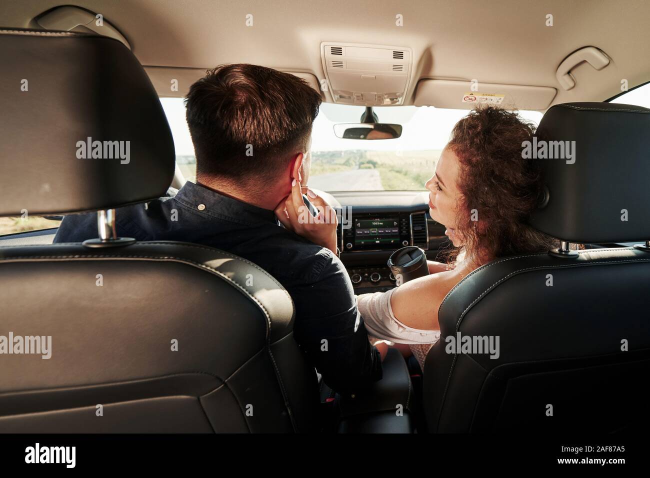 Two young woman sitting backseat car hires stock photography and