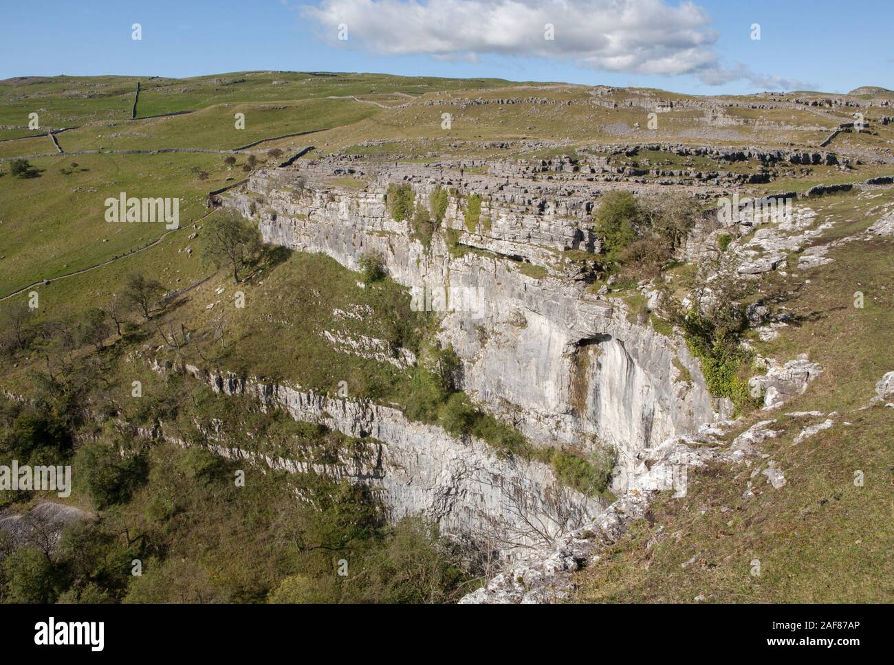 Malham Cove in Yorkshire Dales National Park is a dried up waterfall with a limestone pavement above Stock Photo