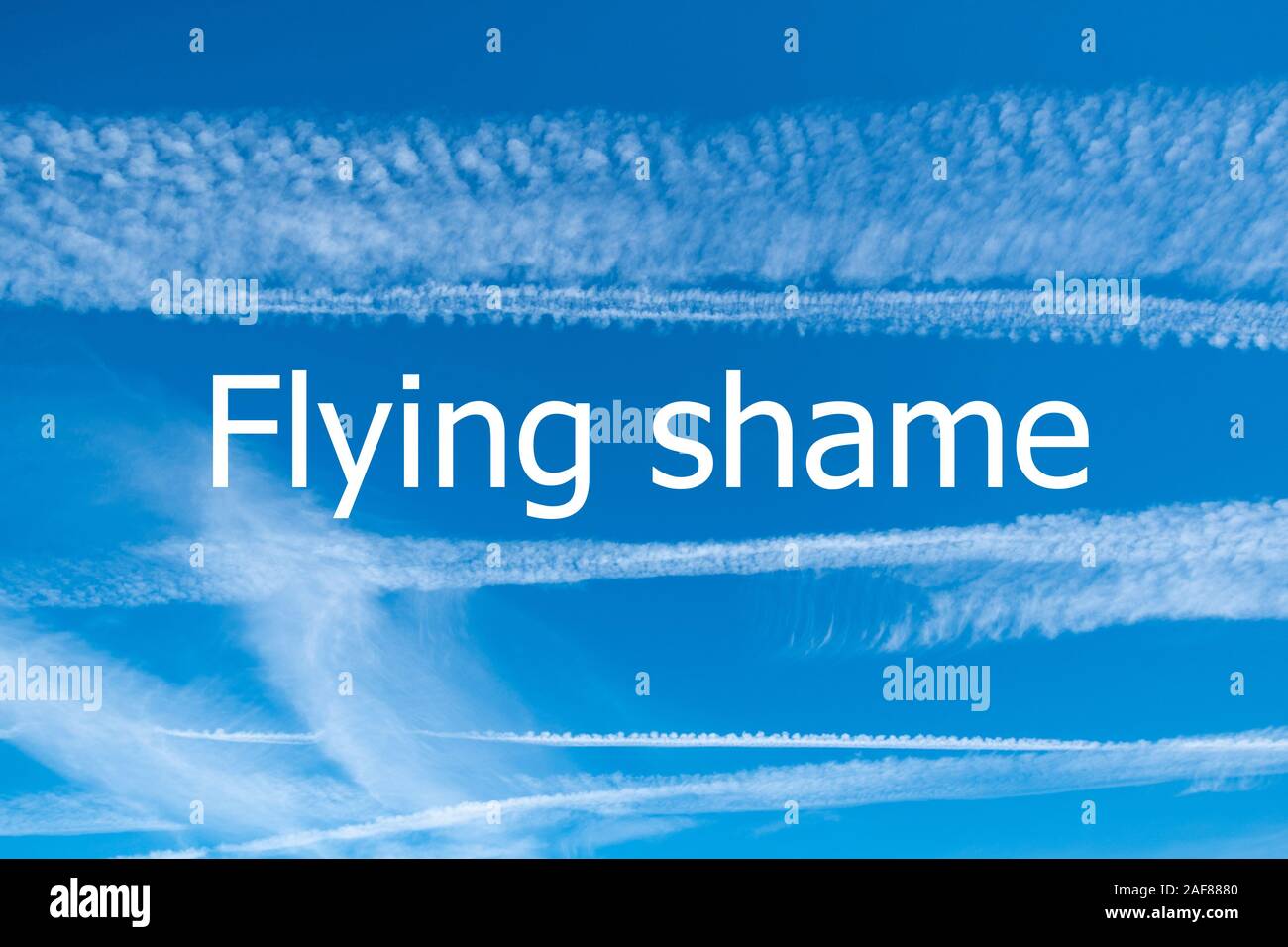Climate change concept image with blue sky and vapour trails from aircraft with the words Flying Shame Stock Photo