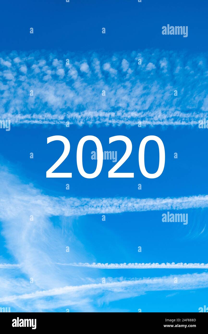 Bly sky with airplane vapour trails and 2020 year - concept of climate change and consequences of flying in the new year Stock Photo