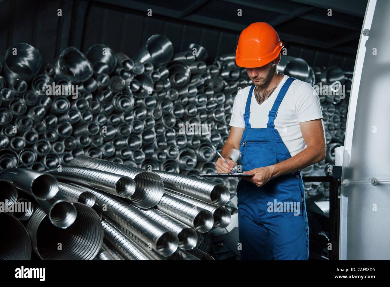 Inspection In Progress Inspection in progress. Man in uniform works on the production ...