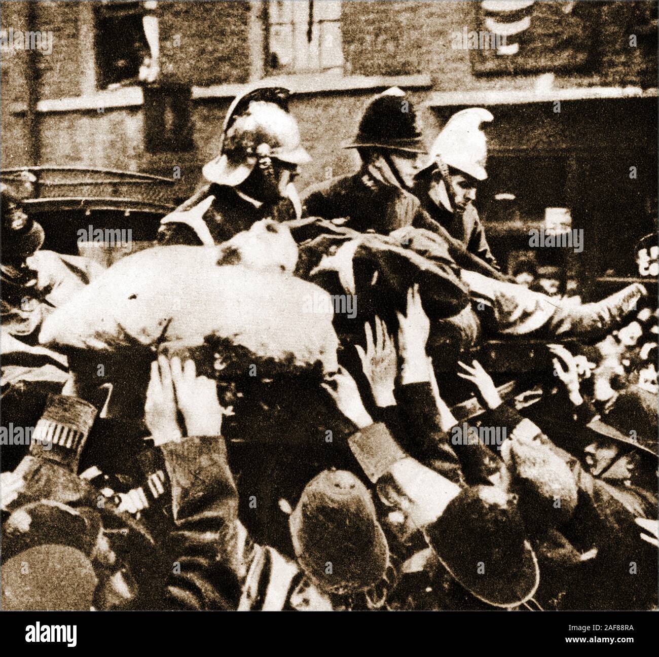 Seige of Sidney Street -The Siege of Sidney Street (January 1911), also known as the Battle of Stepney, took part in the  East End of London between British police supported by soldiers, Following a robbery and the killing of three police officers by Latvian revolutionaries. This historic photograph shows firemen and police attend the burning building after the event. Stock Photo