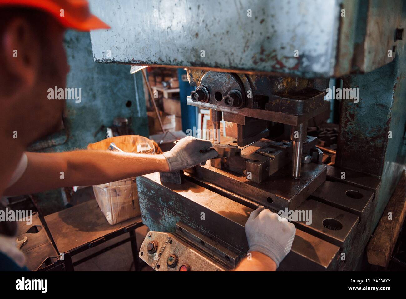 Old machine. Man in uniform works on the production. Industrial modern ...