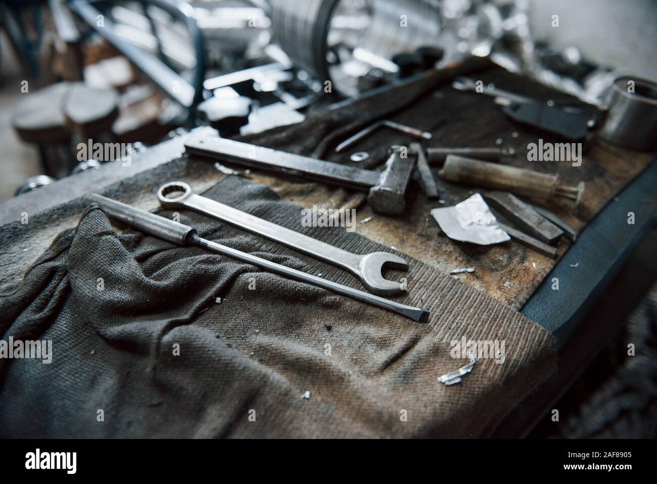 Place of work. Tools on dirty table. In garage. Manufactory conception Stock Photo