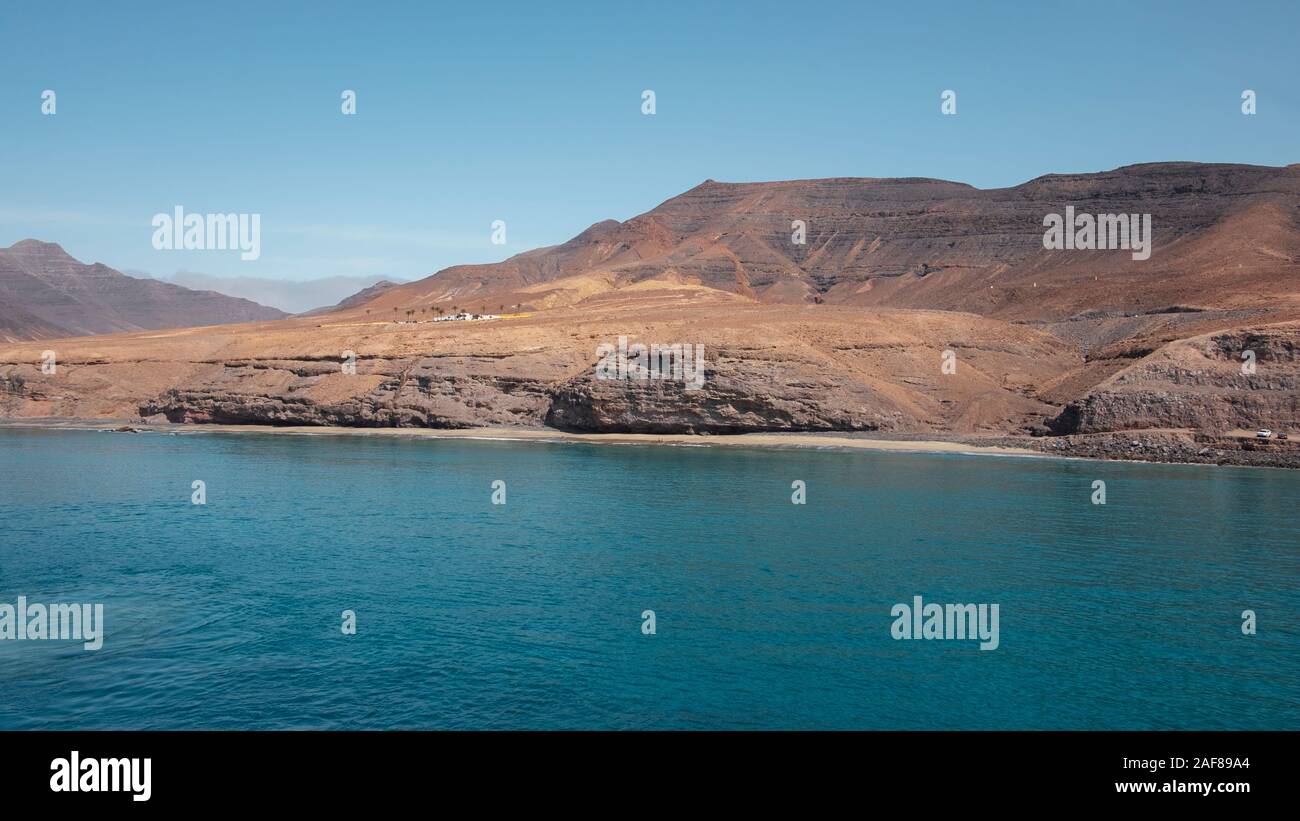 Approaching Fuerteventura island at its most southern point, at Morro Jable with the display of the solitary cliffs part of the Parque Natural Jandia Stock Photo