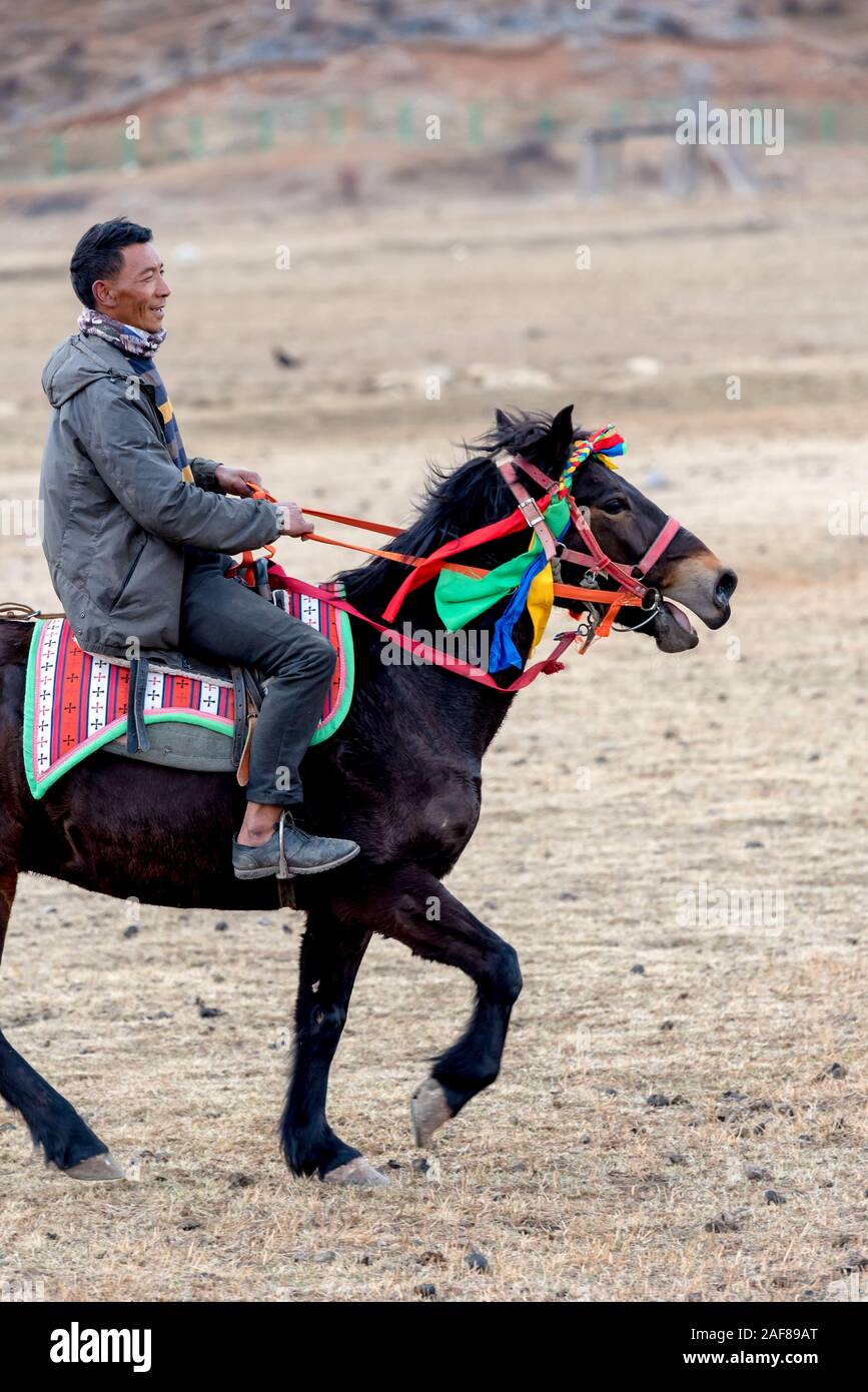 March 21, 2019: Man riding a horse. Shangri-la, Yunnan, China Stock ...