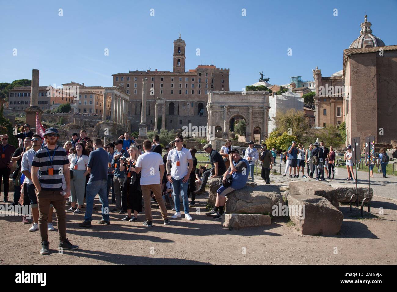 Masses of tourists at the Roman Forum is a forum (plaza) surrounded by the ruins of several government buildings Stock Photo