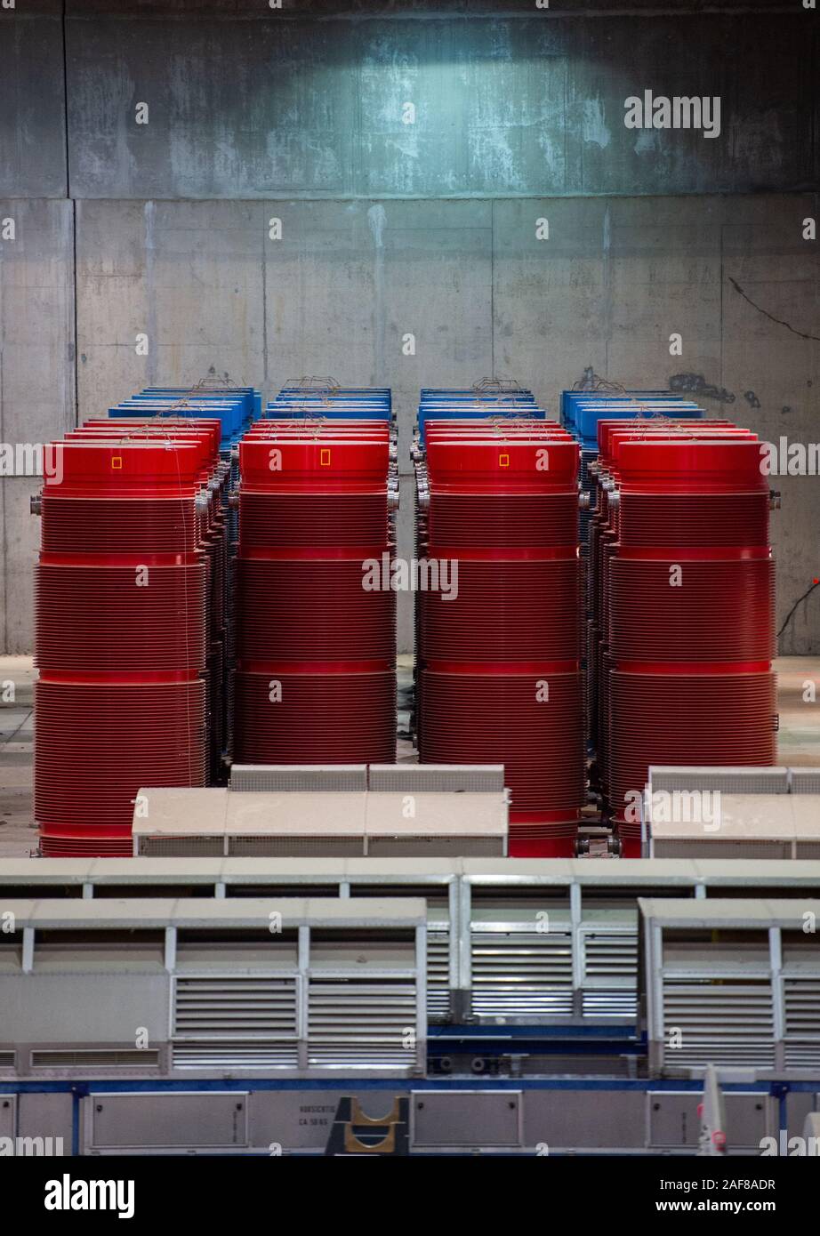 11 December 2019, Lower Saxony, Gorleben: Containers with high-level radioactive waste and transport hoods are in interim storage. The Gorleben nuclear waste storage facility is an interim storage facility for spent fuel elements and high-level radioactive waste. To date, 13 Castor transports with highly radioactive material have reached the transport container warehouse between 1995 and 2011. Until a repository has been found, the nuclear waste is to be temporarily stored there. Photo: Lucas Bäuml/dpa Stock Photo