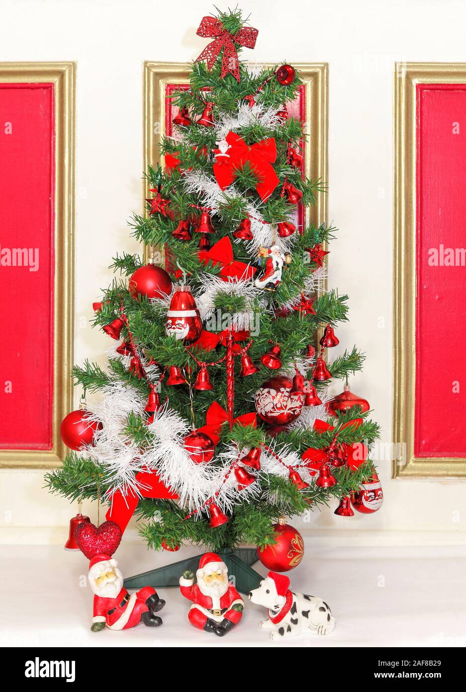 Red and white themed decorated Christmas tree to celebrate the holiday season , Xmas, Noel, Yuletide, Stock Photo