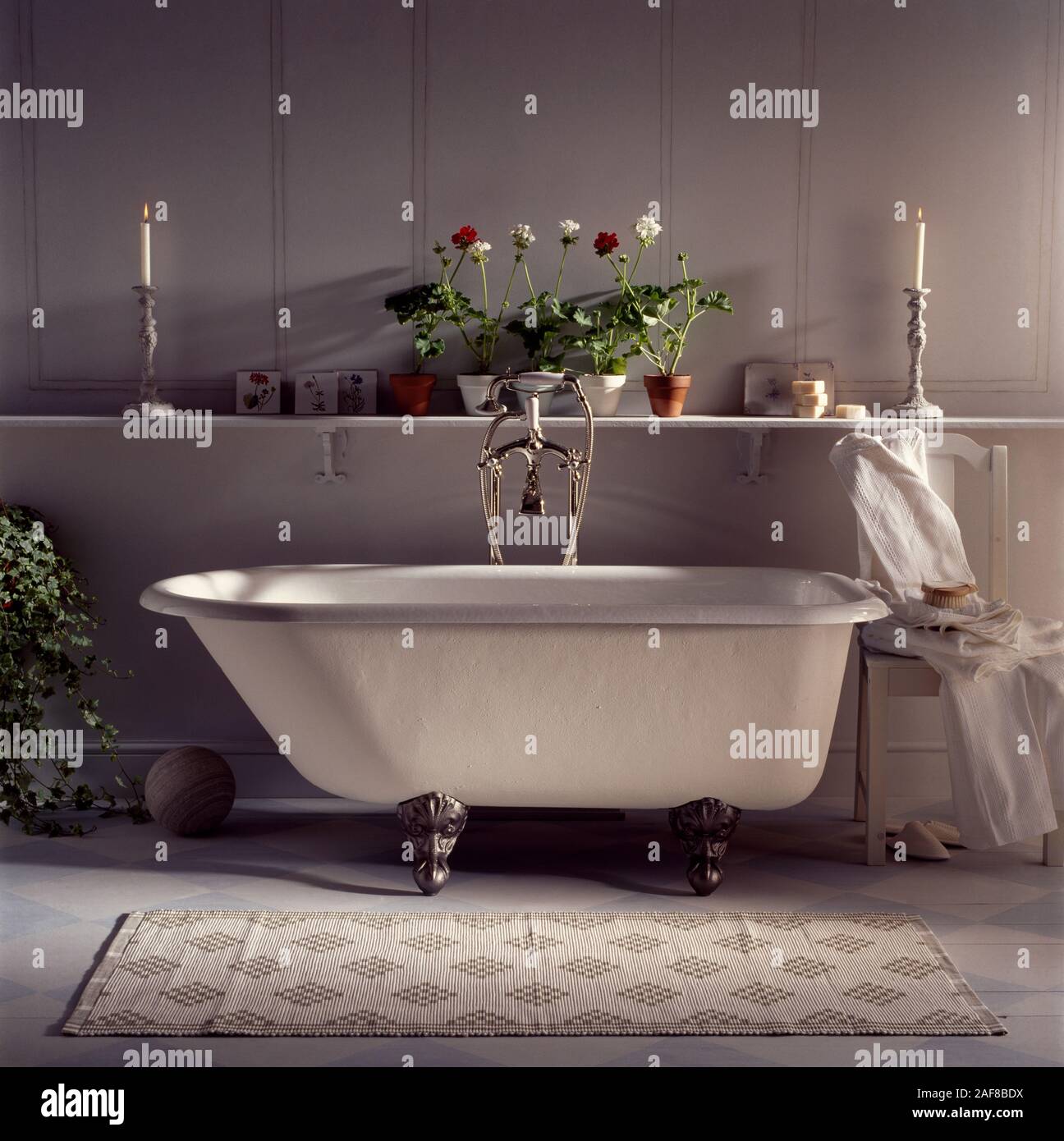 White rolltop bath in neutral decorated bathroom Stock Photo Alamy