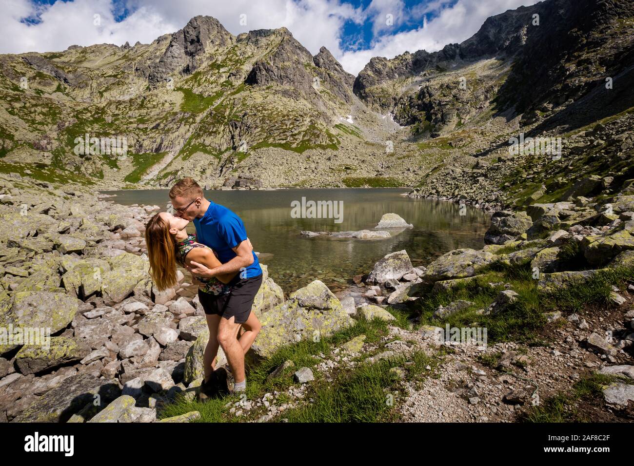 Active tourists couple on the way to Rysy. Path from Slovakia, Strbske, Popradske  pleso, Zabie Ridge, frog's lakes valley and Chata pod Rysmi chalet Stock  Photo - Alamy