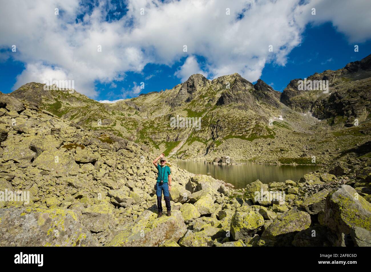 Tourist on the way to Rysy highest peak of Poland. Path from Slovakia,  Strbske, Popradske pleso, Zabie Ridge, frog's lakes valley and Chata pod  Rysmi Stock Photo - Alamy