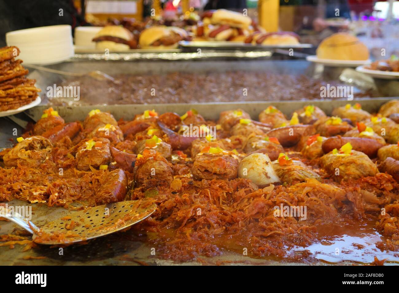 Traditional Eastern European food such as sausages, potato pancakes, goulash and sauerkraut on display at one of Budapest's christmas markets. Stock Photo