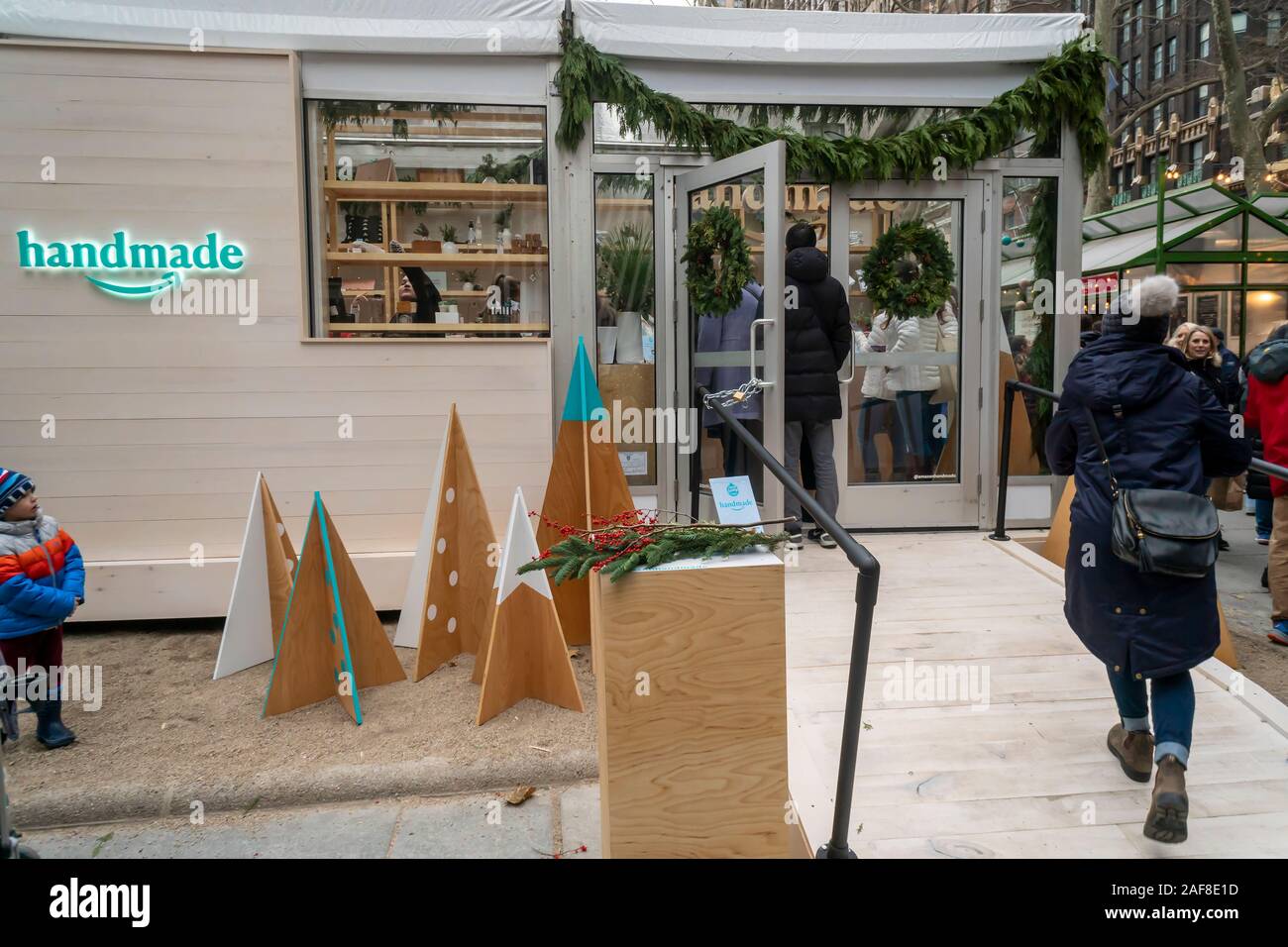 Visitors to Bryant Park in New York on Friday, December 6, 2019 outside the  Amazon Handmade Holiday Market pop-up store. The store sells a curated  selection of artisan made merchandise available on